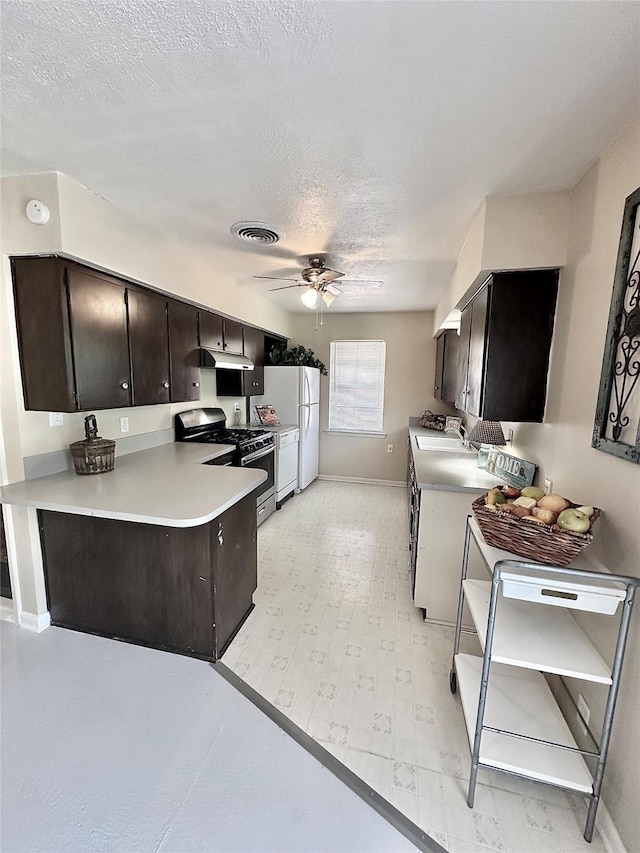 kitchen with visible vents, ceiling fan, washer / clothes dryer, light countertops, and gas stove