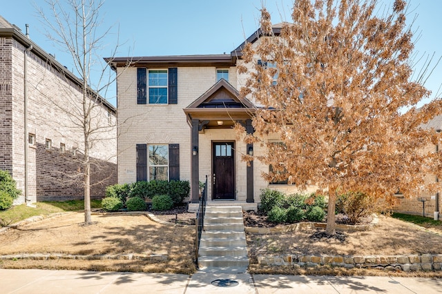 view of front of house with brick siding