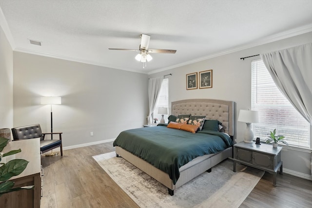 bedroom featuring multiple windows, visible vents, and light wood finished floors