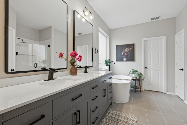 full bath featuring a stall shower, a sink, visible vents, and tile patterned floors