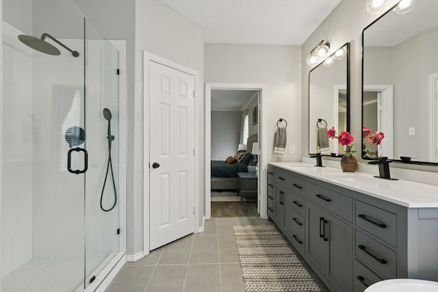 full bath with a stall shower, tile patterned flooring, and a sink