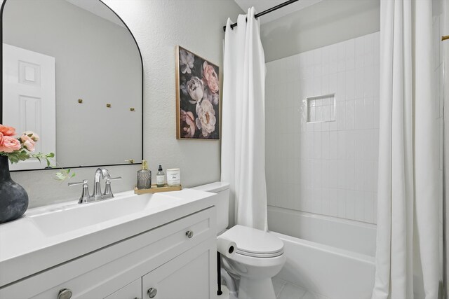 bathroom featuring shower / bath combo, vanity, and toilet