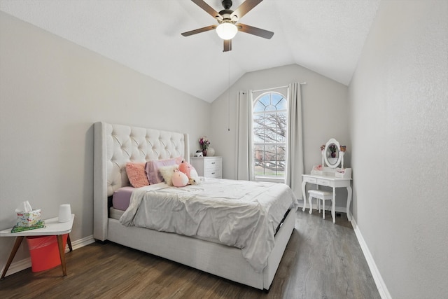 bedroom with vaulted ceiling, baseboards, and wood finished floors