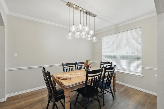 dining area with baseboards, ornamental molding, and wood finished floors