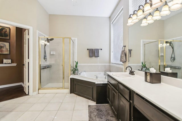 full bathroom with a stall shower, vanity, a bath, and tile patterned floors