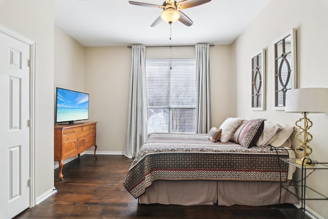 bedroom featuring dark wood-type flooring, baseboards, and a ceiling fan