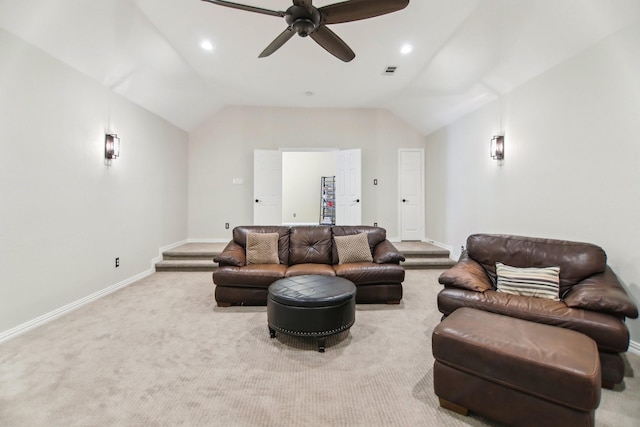 carpeted living area with vaulted ceiling, a ceiling fan, visible vents, and baseboards