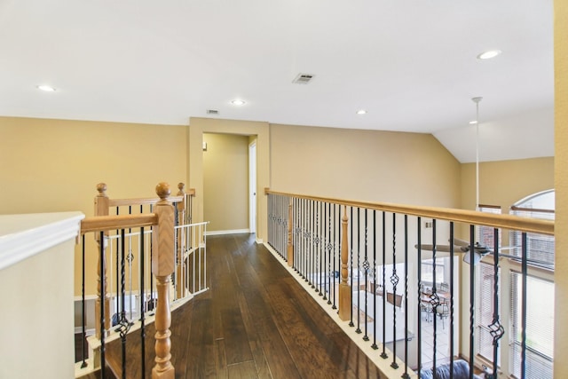 hall with hardwood / wood-style flooring, visible vents, vaulted ceiling, and recessed lighting