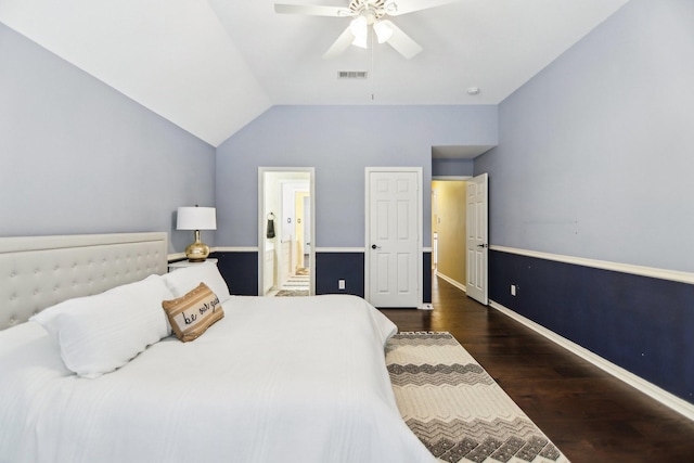 bedroom with visible vents, connected bathroom, vaulted ceiling, wood finished floors, and baseboards