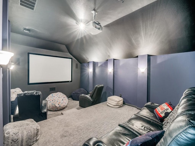 cinema with vaulted ceiling, carpet, and visible vents