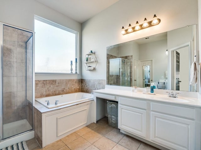 bathroom featuring a garden tub, a shower stall, vanity, and tile patterned floors