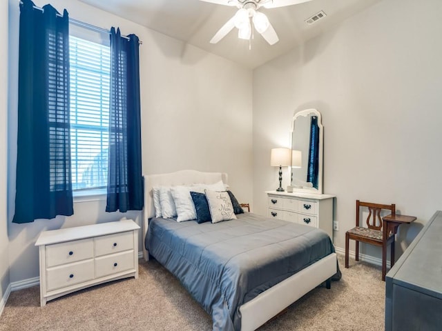 bedroom featuring light carpet, ceiling fan, visible vents, and baseboards