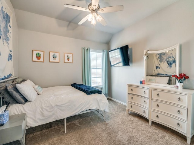 bedroom with light carpet, ceiling fan, baseboards, and vaulted ceiling