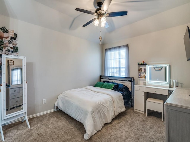 bedroom featuring a ceiling fan, light carpet, and baseboards