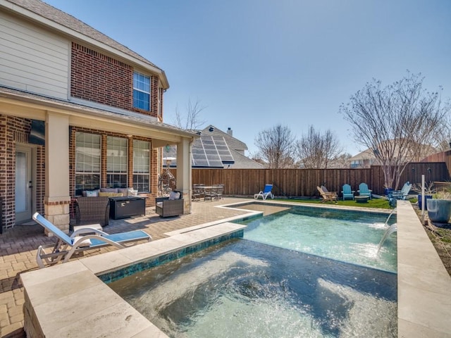 view of swimming pool with a fenced in pool, an outdoor living space with a fire pit, a patio, a fenced backyard, and a jacuzzi