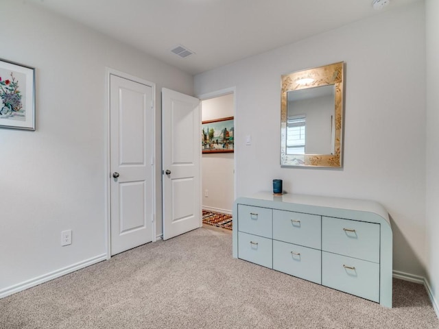 bedroom featuring carpet floors, visible vents, and baseboards