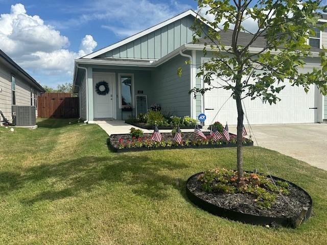 view of front of house with driveway, central AC, board and batten siding, and a front yard