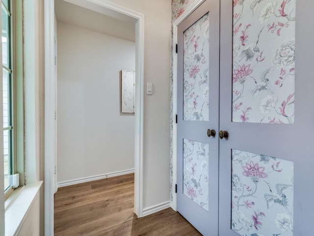 doorway to outside with a wealth of natural light, baseboards, wood finished floors, and french doors