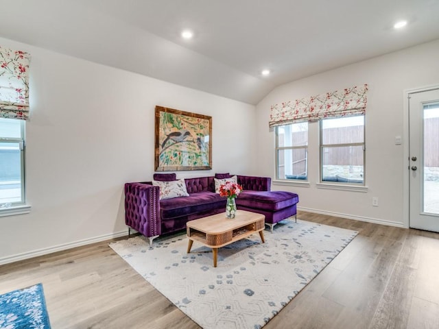 living room featuring recessed lighting, vaulted ceiling, baseboards, and wood finished floors