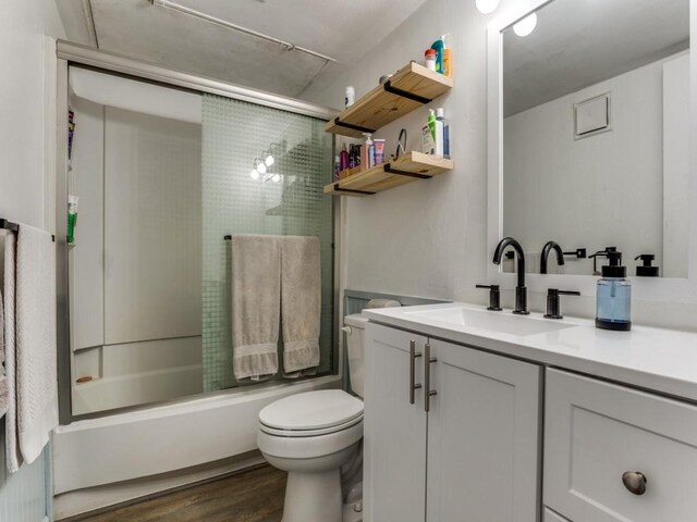 4468 Chaha Rd Unit 101, Garland, TX 75043 - full bath featuring vanity, shower / bath combination with glass door, and wood finished floors