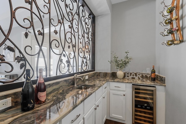 bar with beverage cooler, indoor wet bar, and a sink