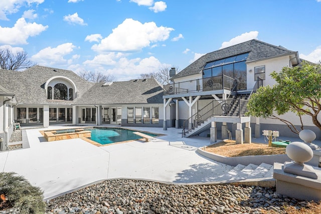 outdoor pool featuring stairs, an in ground hot tub, a patio, and a diving board