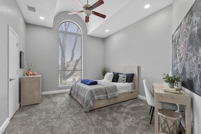 carpeted bedroom with baseboards, multiple windows, visible vents, and vaulted ceiling