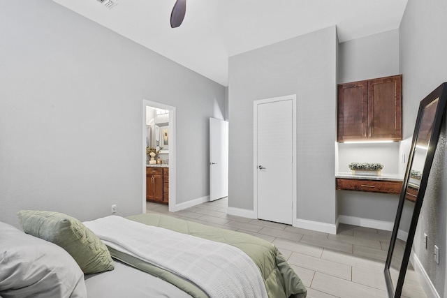 bedroom with a ceiling fan, connected bathroom, and baseboards