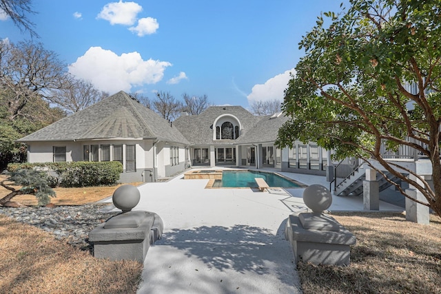 exterior space with a pool with connected hot tub and a patio area