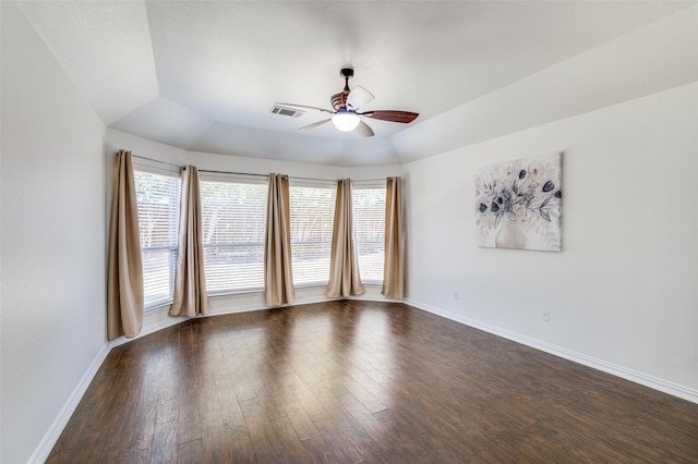 unfurnished room featuring baseboards, dark wood-type flooring, visible vents, and a ceiling fan