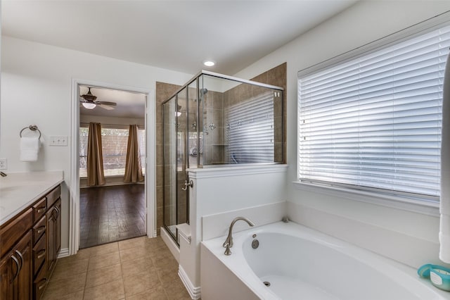 full bathroom featuring tile patterned flooring, plenty of natural light, a shower stall, and vanity