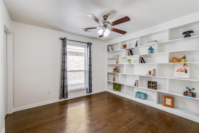 interior space featuring dark wood-style floors, ceiling fan, baseboards, and built in features