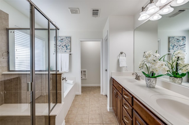 bathroom featuring a bath, a stall shower, a sink, and visible vents