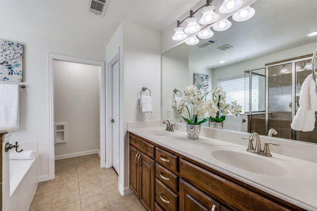 bathroom featuring visible vents, a sink, and tile patterned floors