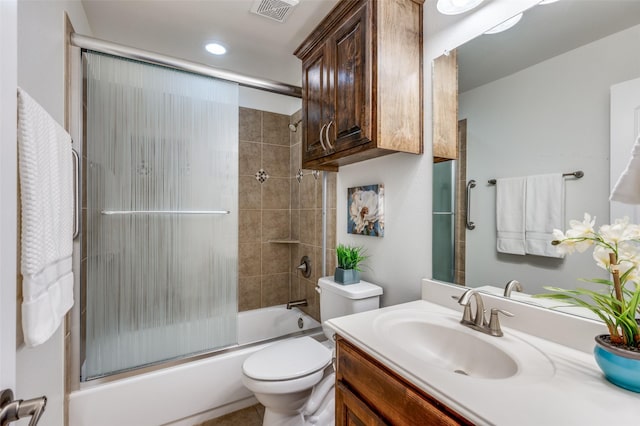 full bath with toilet, enclosed tub / shower combo, visible vents, and vanity