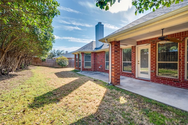 view of yard featuring a patio area, ceiling fan, and fence