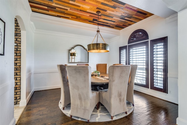 dining area featuring wood ceiling, crown molding, a raised ceiling, and dark wood-style flooring