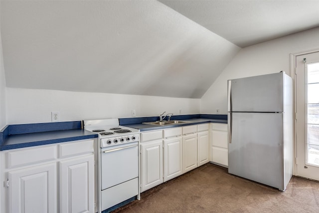 kitchen featuring white electric stove, carpet, freestanding refrigerator, and white cabinets