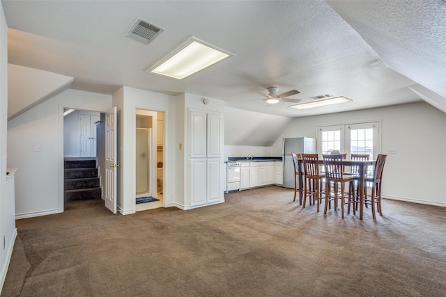 bonus room with carpet, visible vents, vaulted ceiling, and a textured ceiling