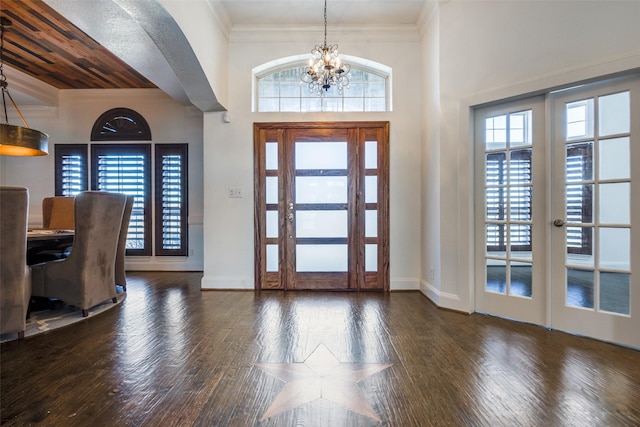 foyer entrance with a wealth of natural light, french doors, and wood-type flooring