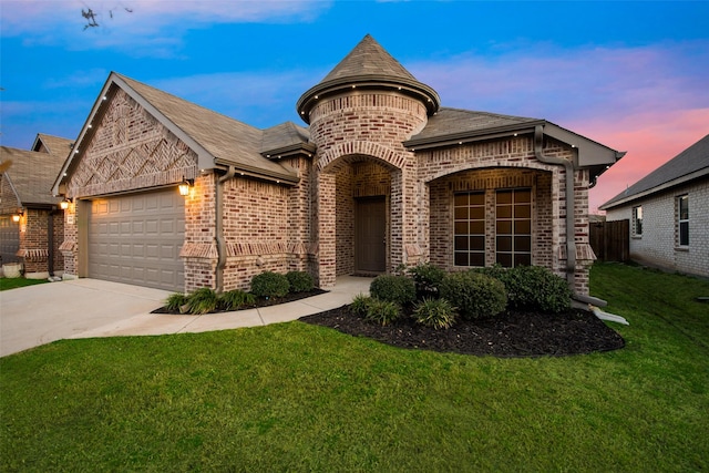 french country style house featuring a garage, concrete driveway, brick siding, and a front lawn