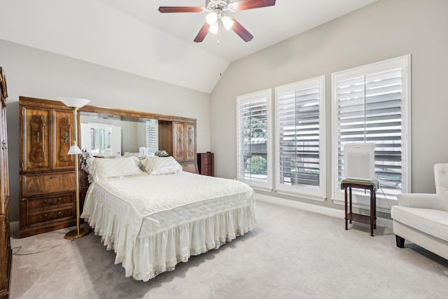 bedroom featuring light carpet, lofted ceiling, a ceiling fan, and baseboards