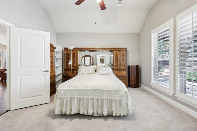 bedroom featuring light carpet, visible vents, baseboards, lofted ceiling, and ceiling fan