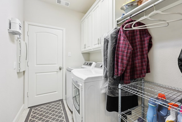 laundry room with visible vents, cabinet space, washer and clothes dryer, and baseboards