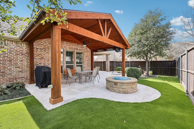 view of patio / terrace with a fenced backyard, a grill, a fire pit, and ceiling fan