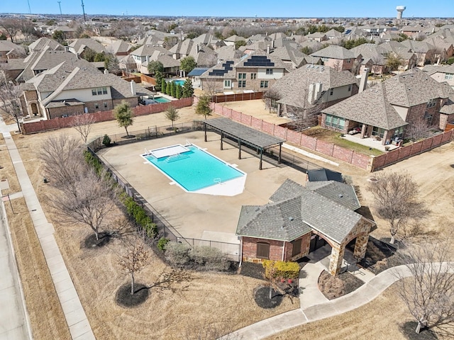 view of pool featuring fence and a residential view