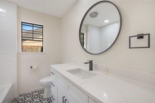 bathroom with toilet, vanity, baseboards, a shower, and a bath