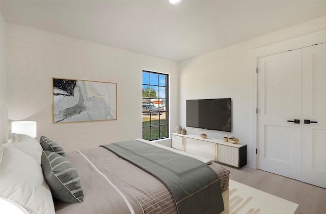 bedroom with a closet and wood finished floors