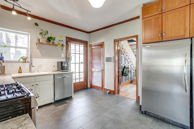 kitchen featuring stainless steel appliances, a sink, ornamental molding, decorative backsplash, and open shelves