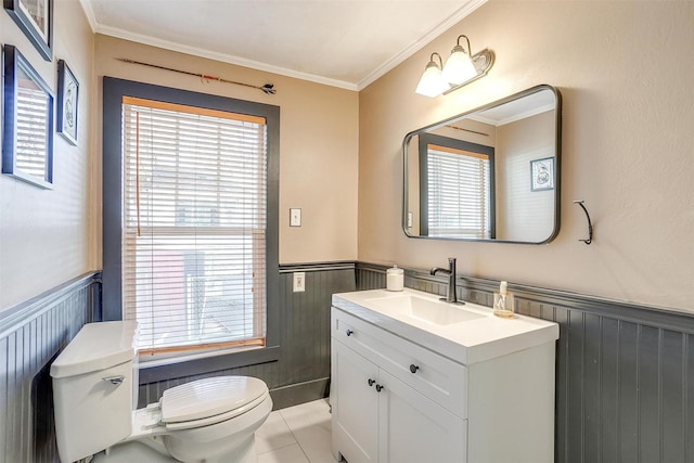 half bathroom with a wainscoted wall, plenty of natural light, and toilet